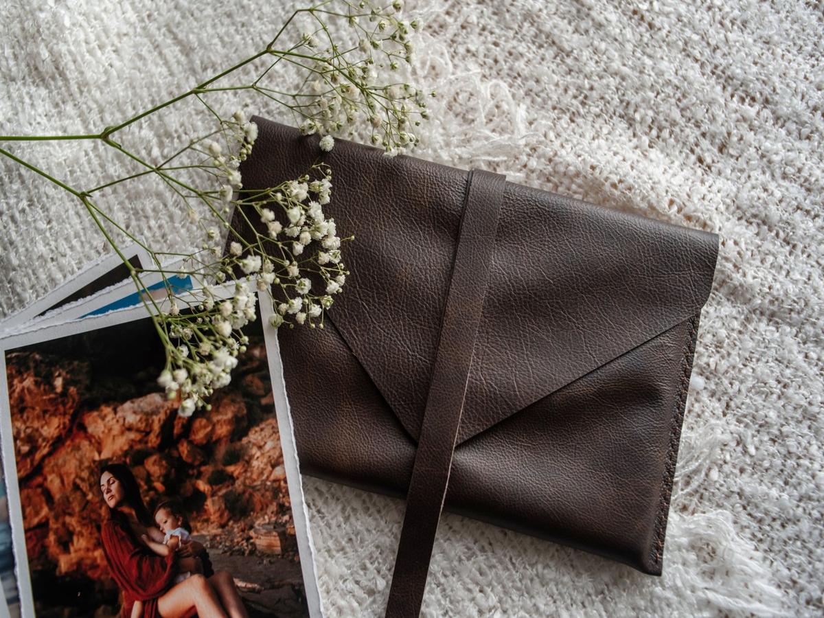 A warm and intimate print paired with a handcrafted leather envelope from QT Albums — styled with soft textures and delicate florals for a timeless presentation.