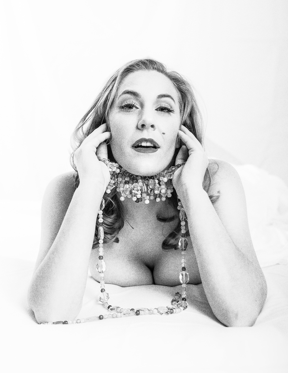 Close-up boudoir beauty portrait showcasing professional camera-ready hair and makeup artistry under studio lighting